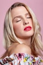 Portrait of beauty young  blonde woman with closed eyes on pink background Royalty Free Stock Photo