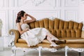 Portrait of beauty young sexy and attractive sensuality brunette woman in elegant dress sitting on sofa