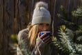 Portrait of beauty young woman drink from blue cup of tea in white cap Royalty Free Stock Photo