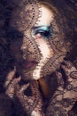 portrait of beauty young woman through lace close up mistery mak Royalty Free Stock Photo