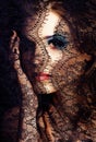 portrait of beauty young woman through lace close up mistery mak Royalty Free Stock Photo