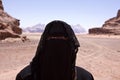 Portrait of Bedouin woman with burka in desert Royalty Free Stock Photo