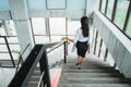 Portrait from behind of businesswoman walking down stairs alone Royalty Free Stock Photo