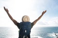 Carefree african american travel man with bag and raised arms