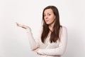 Portrait of bewildered puzzled young woman in light clothes looking camera, pointing hand aside isolated on white