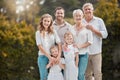 Portrait of big family in garden together with smile, grandparents and parents with kids in backyard. Nature, happiness Royalty Free Stock Photo