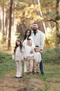 Portrait of big family outdoors. Young Stylish bearded dad with little son on shoulder, beautiful brunette mom, child Royalty Free Stock Photo