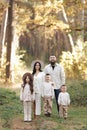 Portrait of big family outdoors. Young Stylish bearded dad with little son on shoulder, beautiful brunette mom, child Royalty Free Stock Photo