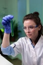 Portrait of biochemist doctor looking at medical test tube with green dna solution Royalty Free Stock Photo