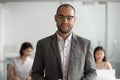 Portrait of biracial male employee in glasses posing at workplace Royalty Free Stock Photo