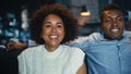 Portrait of Black Couple Laughing Out Loud While Watching Comedy Late Night Show on TV During the Royalty Free Stock Photo