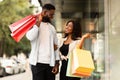 Portrait of black couple walking with shopping bags Royalty Free Stock Photo