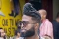 La Havana, Cuba, January 08, 2017: Portrait of a black cuban man with sunglasses on street from la Havana. Afrocaribbean rasta cu