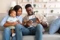 Portrait of black family using digital tablet at home Royalty Free Stock Photo