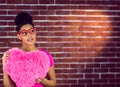 Portrait black hair model holding a pink heart shaped pillow Royalty Free Stock Photo