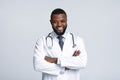 Portrait of black male doctor with stethoscope on white background