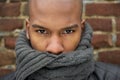 Portrait of a black male fashion model with gray scarf covering face