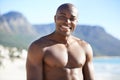 Portrait of black man on beach, holiday and smile with freedom, sunshine and tropical island travel. Sea, mountain and Royalty Free Stock Photo