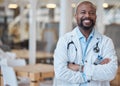 Portrait, black man and happy doctor with arms crossed in hospital for healthcare. African medical professional, face Royalty Free Stock Photo