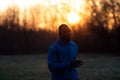 Portrait of a black man running outdoor while the sun rises