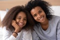 Portrait of black mother and daughter smiling at camera