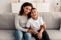 Portrait of black mother and son hugging on couch Royalty Free Stock Photo