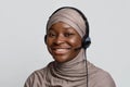 Portrait of black muslim call center operator lady in hijab and headset Royalty Free Stock Photo