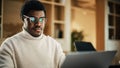 Portrait of Black Productive Young Man Working on Laptop in a Cotemporary Office. Businessman