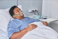 Black senior woman laying on bed in hospital room with oxygen support Royalty Free Stock Photo