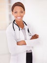 Portrait, black woman and doctor with arms crossed, smile and confident employee with a stethoscope, lab coat and Royalty Free Stock Photo
