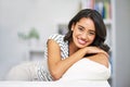 Portrait, black woman and smile on sofa, relax and happy in lounge being calm. Young female, girl and happiness Royalty Free Stock Photo