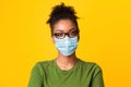 Portrait of black woman wearing medical mask and glasses Royalty Free Stock Photo