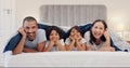 Portrait, blanket and children with parents in bed relaxing and bonding together at family home. Smile, happy and young Royalty Free Stock Photo