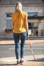 Portrait blind woman crossing road holding stick