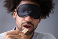 Portrait Of Blindfolded Man Tasting Food Royalty Free Stock Photo