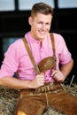 Blond bavarian man sitting on a haystack Royalty Free Stock Photo