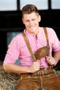 Blond bavarian man sitting on a haystack Royalty Free Stock Photo