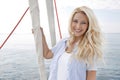 Portrait of blond beautiful young woman on sailing boat.