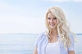 Portrait of blond beautiful young woman on sailing boat.