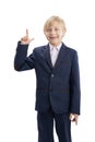 Portrait of blond boy in school uniform with hand raised up isolated on white background. Vertical frame. Bright student Royalty Free Stock Photo