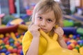 Portrait of a blond boy in a yellow t-shirt.