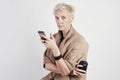 Portrait of blond caucasian woman emotion drinks takeaway coffee, using smartphone on white background