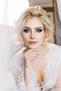 Portrait of a blond girl in a negligee with a beautiful hairdo a Royalty Free Stock Photo