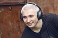 Portrait of a guy with headphones on a grunge background