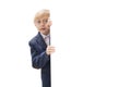 Portrait of blond little boy with white blank isolated on white background. Boy with glasses and school uniform peeking out from Royalty Free Stock Photo