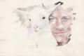 Portrait of blond man holding a little white goat Royalty Free Stock Photo