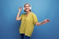 portrait of a blond mature aged woman with a gadget to listen to songs on a studio background with copy space Royalty Free Stock Photo