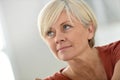 Portrait of blond senior woman at home