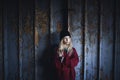 Portrait of blond teenager girl standing indoors in abandoned building.