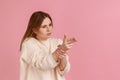 Woman pointing finger gun to camera, aiming and threatening to shoot with pistol hand gesture. Royalty Free Stock Photo